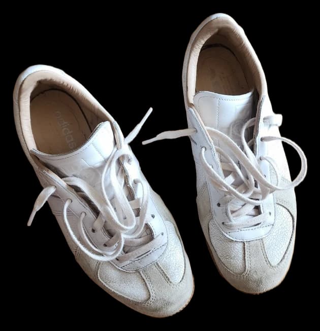 White Adidas low-top sneakers with pale suede trim and white laces